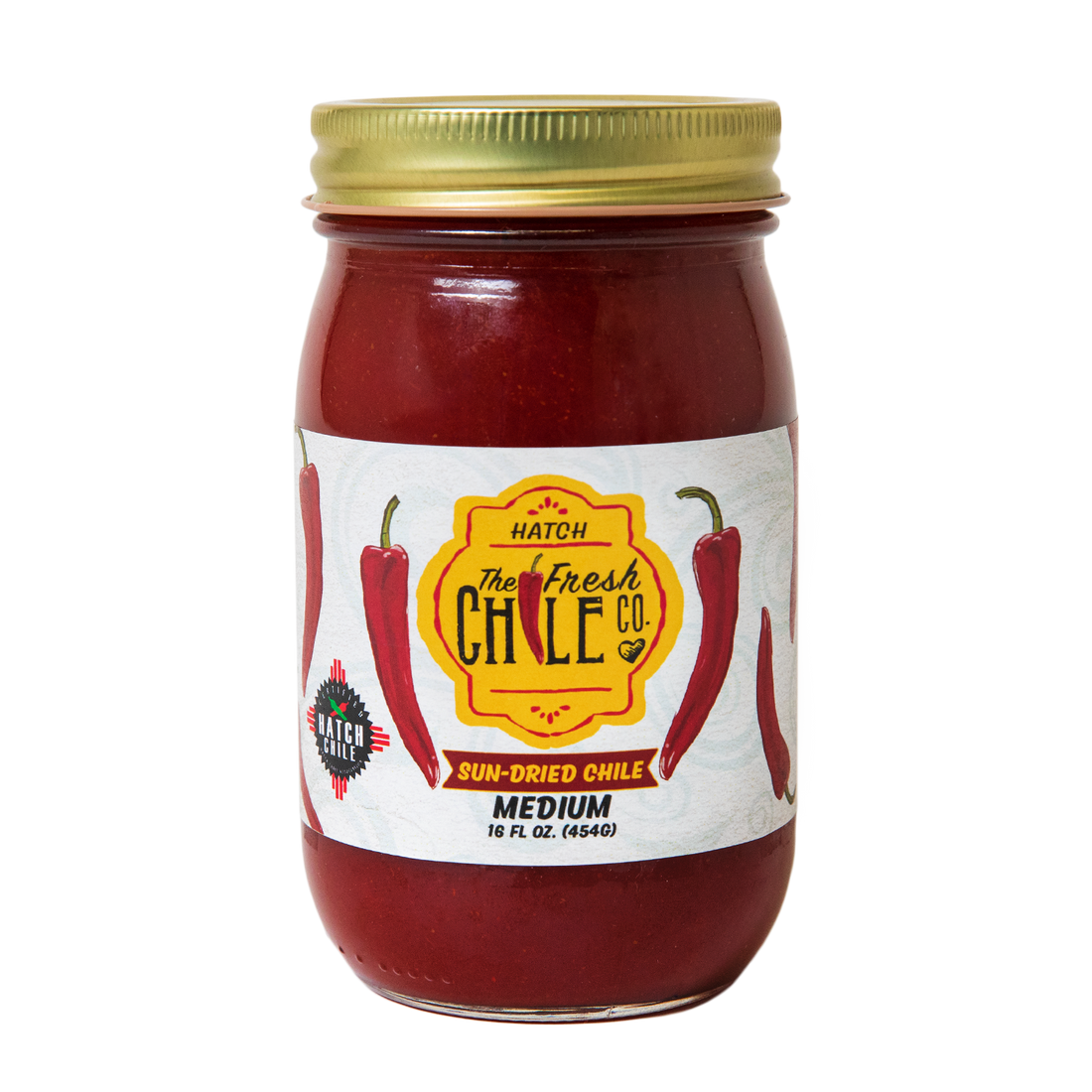 A jar of Fresh Chile Company sun-dried chile, featuring vibrant red dried chile pieces inside a clear glass jar with a lid, labeled with the company branding, set on a clean, neutral surface.