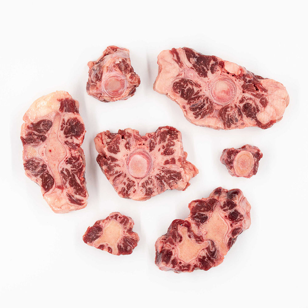 Raw oxtail pieces from Hassell Cattle Company, showcasing rich marbling and quality cuts, perfect for slow cooking or braising.