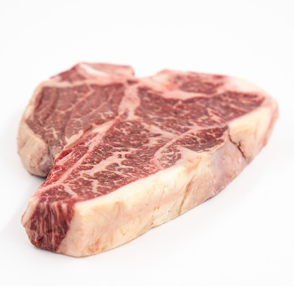 Porterhouse steak from Hassell Cattle Company, a perfectly marbled cut offering both tenderloin and strip steak in one, ideal for grilling or pan-searing.