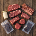 Full contents of the Ranch Week Box: two NY strips, two Denver steaks, two Gold filets, beef bacon, a jar of tallow, and two bags of Wagyu jerky