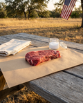 Premium NY Strip on butcher paper at a Texas backyard table for the Premium Cast-Iron Table