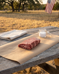 Denver steak on butcher paper at a Texas backyard table for the Denver and Strip Grill Pack