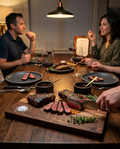 Steakhouse at home lifestyle image using New York strips in a premium dinner setting.