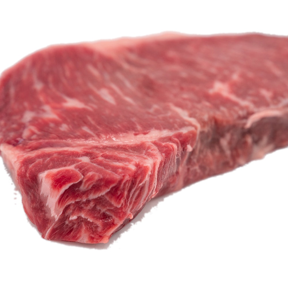 A beautifully marbled New York Strip steak from Hassell Cattle Company, known for its rich flavor and tender texture.