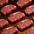 Premium NY Strip Box abundance image showing multiple raw New York strips in a premium editorial layout.