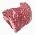 A well-marbled, boneless tri-tip cut of beef, showcasing its tender texture and rich red color, set on a clean, crisp white surface.
