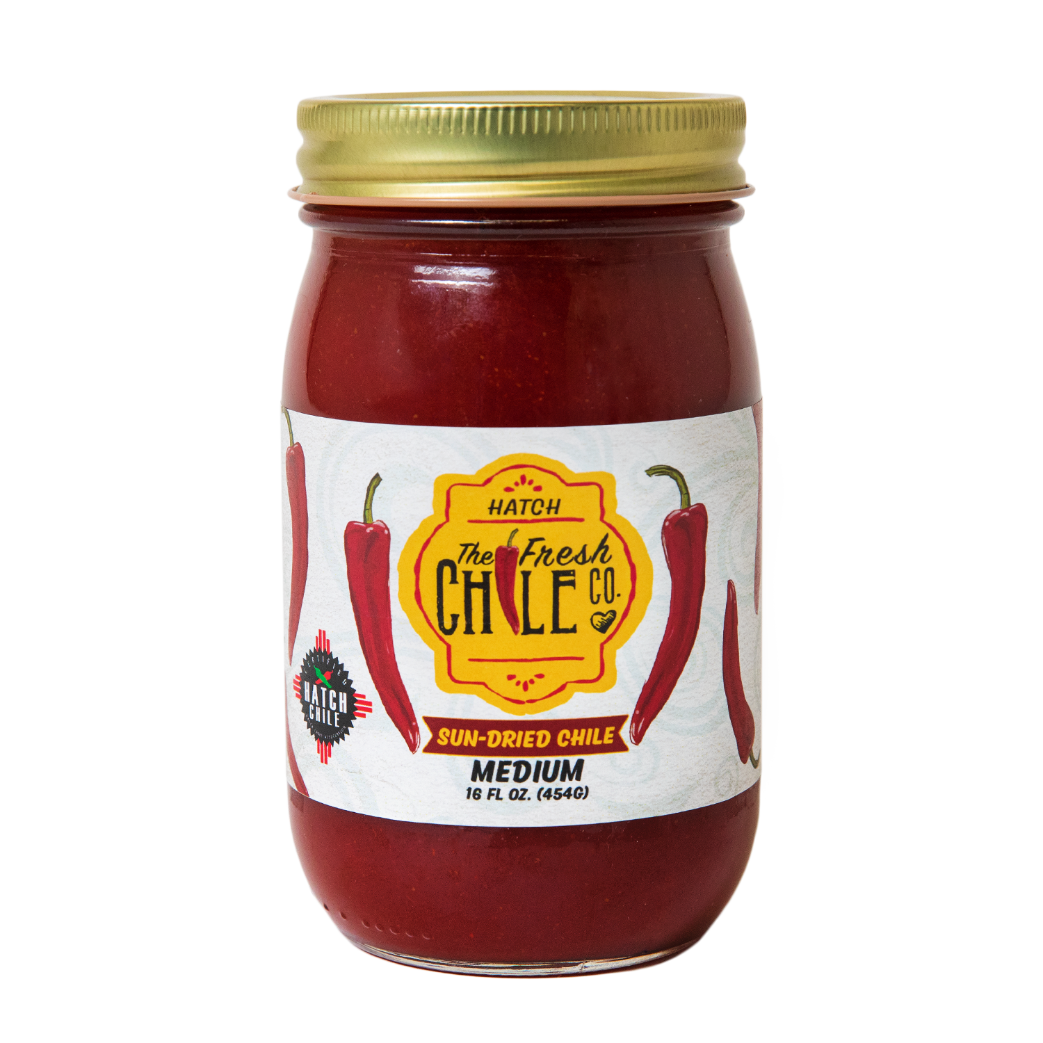 A jar of Fresh Chile Company sun-dried chile, featuring vibrant red dried chile pieces inside a clear glass jar with a lid, labeled with the company branding, set on a clean, neutral surface.
