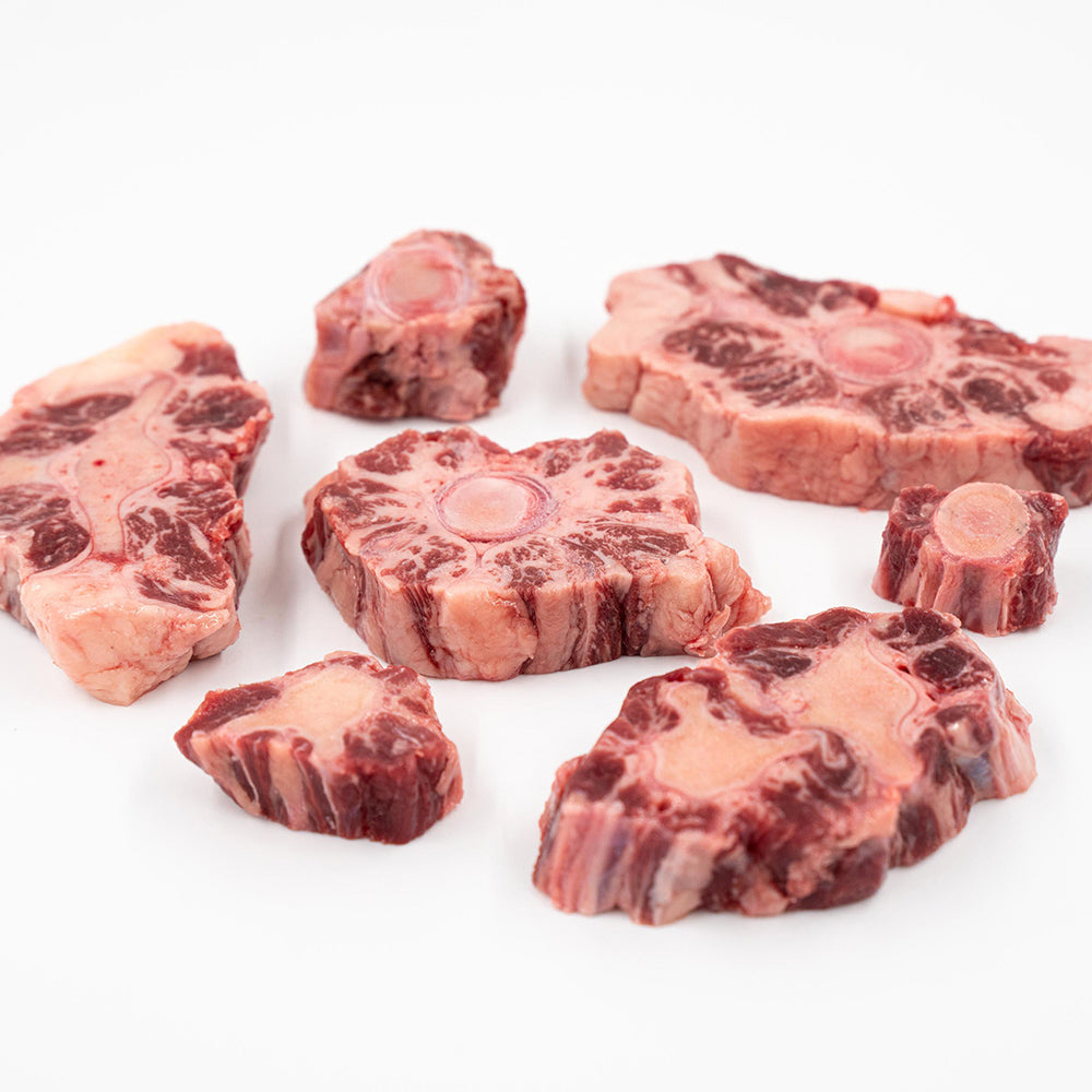 Raw oxtail pieces from Hassell Cattle Company, showcasing rich marbling and quality cuts, perfect for slow cooking or braising.